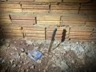 Faca encontrada ao lado da parede nos fundos do imóvel, apontada como uma das armas do crime.