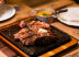 Beef T-Bone Cajun. O prato caseiro e manteiga de chalota. Milho cremoso acompanha o prato especial