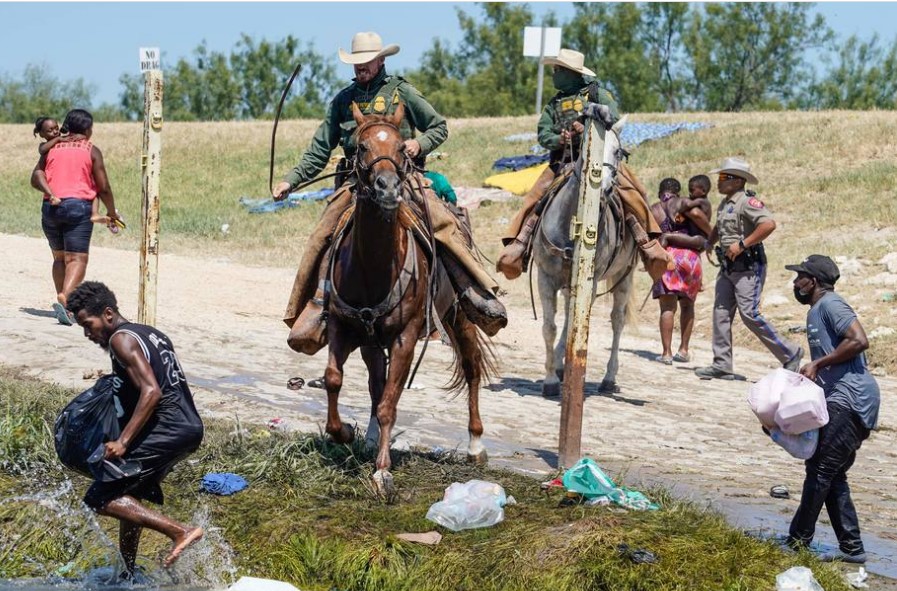Montado a cavalo, agente da Patrulha de Fronteira dos EUA tenta impedir migrantes haitianos de chegarem a solo americano