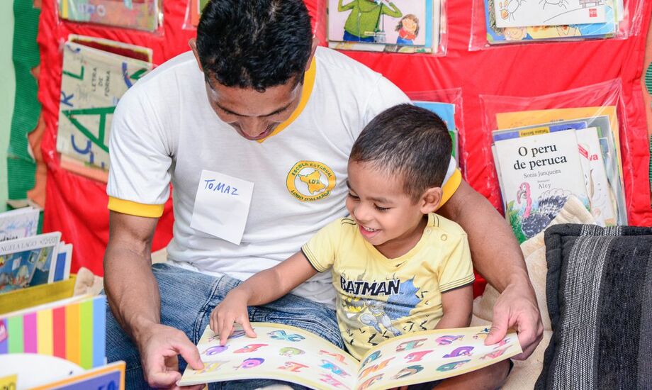Criança sendo incentivada a tomar gosto pela leitura