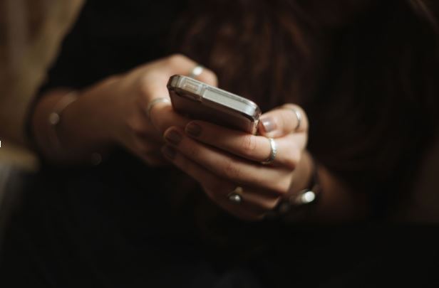 Pessoa segura celular nas mãos