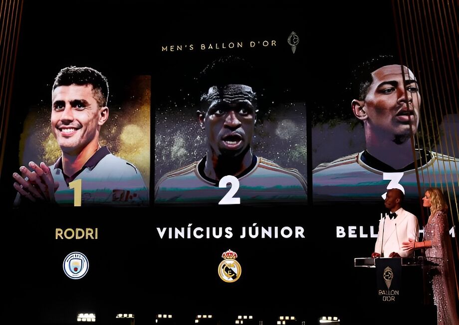 Manchester City's Spanish midfielder Rodri (L) receives the Ballon d'Or award from former President of Liberia and former Liberian football player George Weah (2L) as he wins in front of second-placed Real Madrid's Brazilian forward Vinicius Junior and th