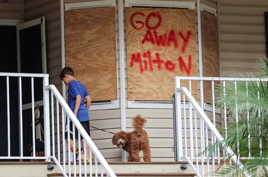 Menino protege a sua casa com uma placa de madeira em Port Richey, Flórida