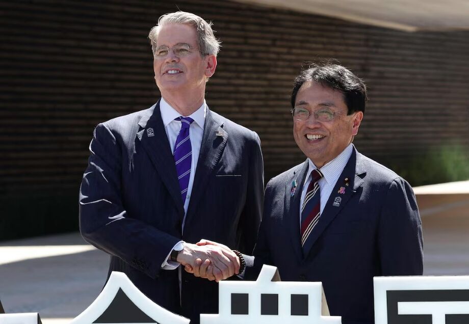 Scott Bessent e o ministro da Revitalização Econômica do Japão, Ryosei Akazawa, possam para fotos em frente ao pavilhão dos EUA na Exposição Mundial em Osaka