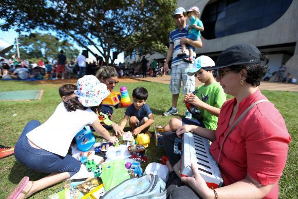 Brasília - Karina Ribeiro (à direita), levou os filhos para a feira de troca de brinquedos durante o Dia Mundial do Brincar, no CCBB ( Marcelo Camargo/Agência Brasil)
