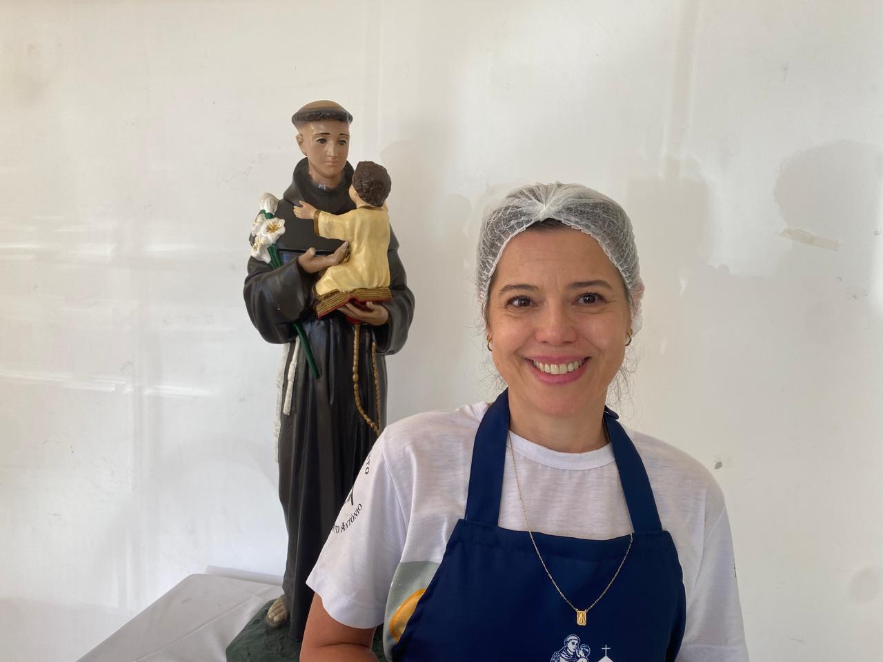 A confeiteira, Fernanda Côrrea, 51, ao lado da imagem de Santo Antônio 
