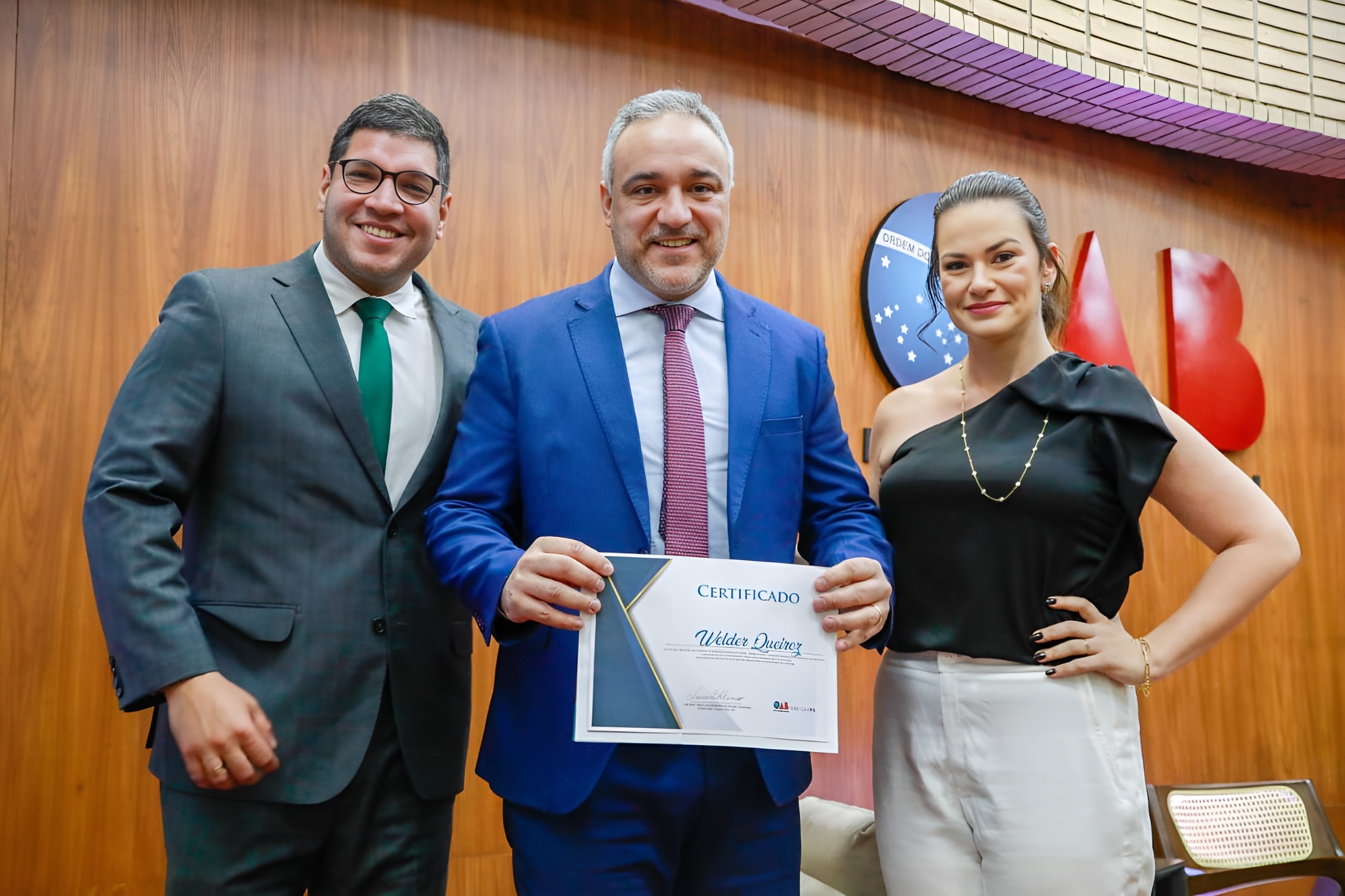  O advogado Welter Queiroz recebe certificado de participação após sua palestra sobre Apelação e Agravo de Instrumento no 2º Fórum de Processo Civil, ao lado de João Grotti e Heloysa Furtado.