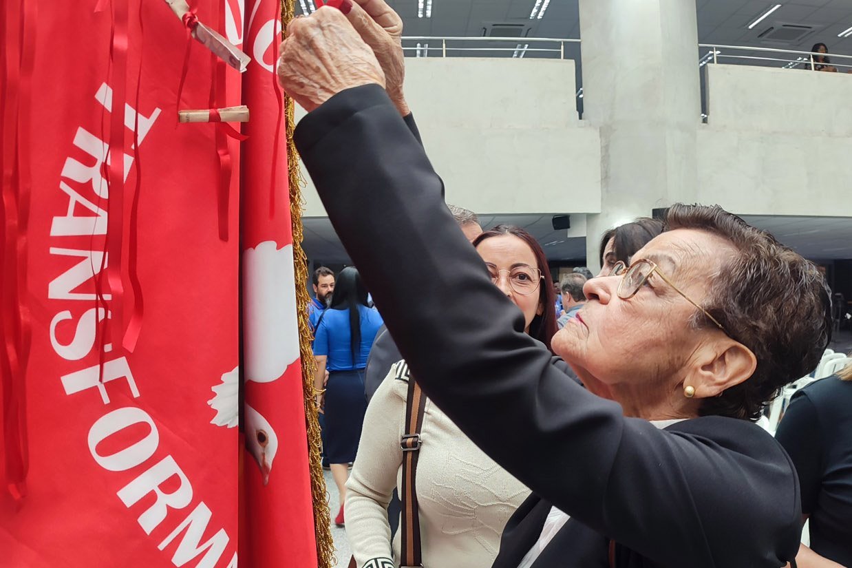 Fitas são amarradas pelos fiéis na Bandeira do Divino, cada uma representando uma graça ou pedido Foto: Luciana Nassar