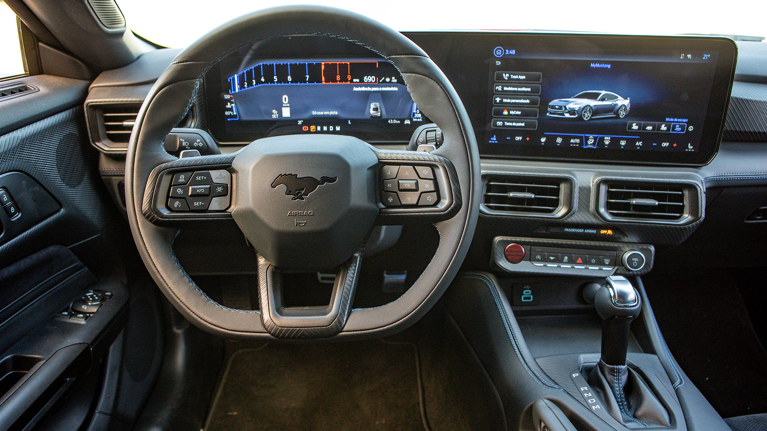 Painel digital e volante com emblema Mustang revelam o interior focado na performance.